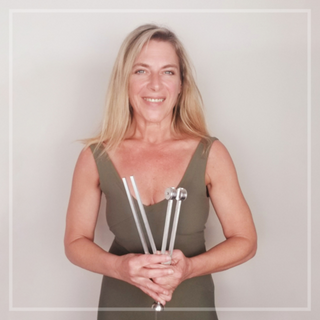 An image of Eileen McCusick holding a sound healing tuning fork for this video on getting electrically healthy