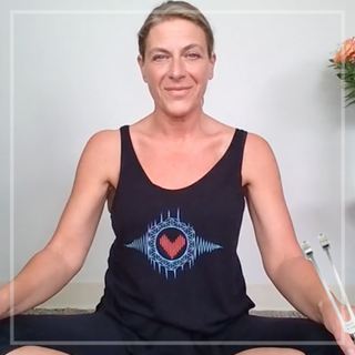 Image of Eileen McKusick with the sonic slider tuning fork for this sound healing stretching & breathing video