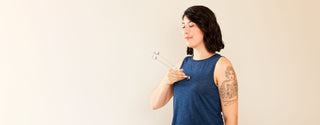 Woman tuning herself with a tuning fork