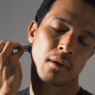 Man using Tuning Fork Circuit Boot on face for sound healing