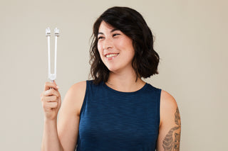 Woman holding the Sonic Slider Tuning Fork