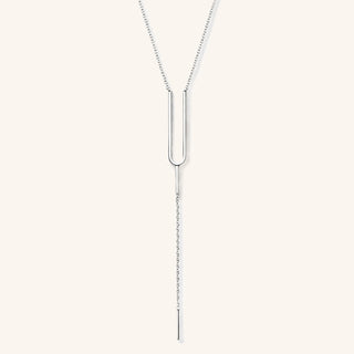 Handmade Tuning Fork Lariat Necklace in sterling silver on a neutral background.