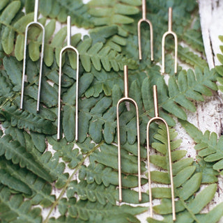 Large Handmade Tuning Fork Earrings in sterling silver and solid brass displayed on ferns.