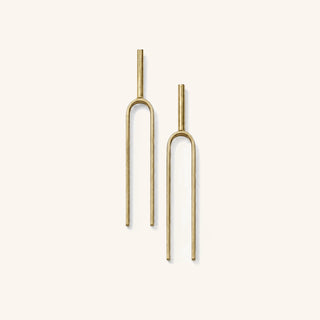Large Handmade Tuning Fork Earrings in solid brass on a neutral background. 