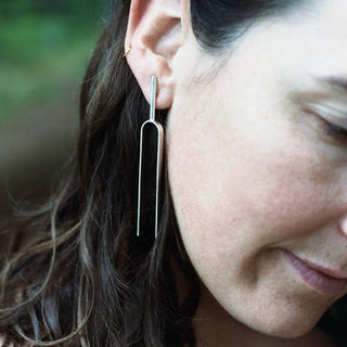 Model wearing Large Handmade Tuning Fork Earrings in sterling silver.
