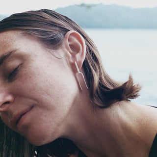 Model wearing Small Handmade Tuning Fork Earrings in sterling silver. 