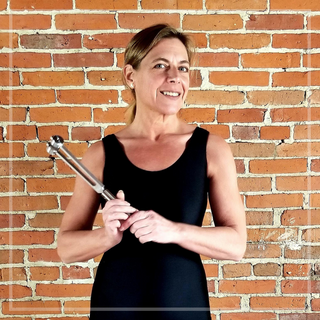 Image of Eileen McKusick holding the sonic slider tuning fork for this educational sound healing video