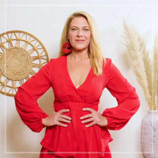 Eileen McKusick standing proudly with both hands on her hips for this sound healing video on loving your body